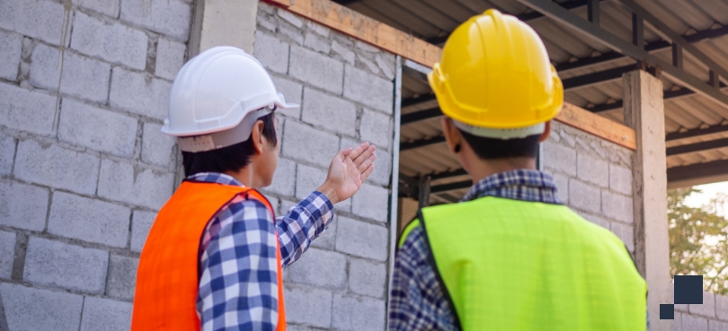 Construction defects, two construction employees reviewing site