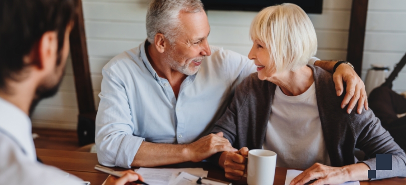 Estate Planning and Probate paperwork being reviewed by couple at home with attorney